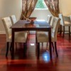 A dining room with hardwood floors.
