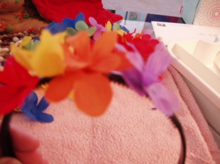 Gluing flowers onto headband.