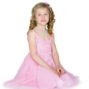 A girl in a pink pageant dress.