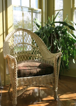 Wicker chair in a sunroom.