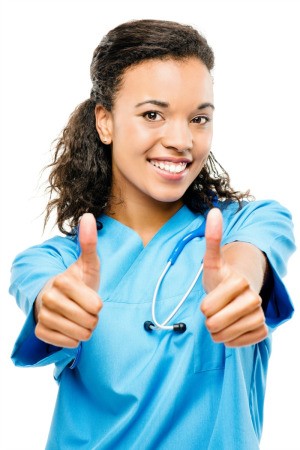 A happy nurse giving two thumbs up.