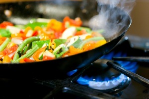 A healthy meal of wok fried vegetables being prepared.