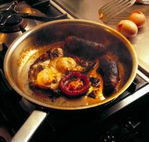 Breakfast burnt and stuck to the bottom of a pan.