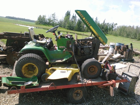 Riding mower on trailer.