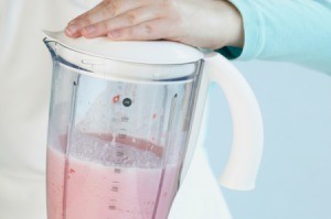 Blender being used to make a smoothie.