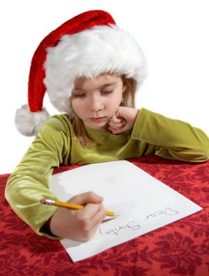 A girl writing a Christmas wish list.