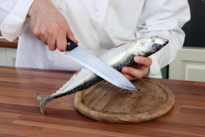 chef cleaning a fish