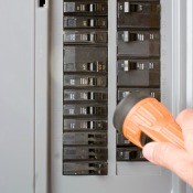 Person looking at circuit breakers.