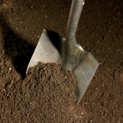A shovel in dirt with no vegetation.