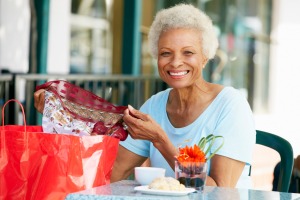 Senior Woman eating lunch after shopping