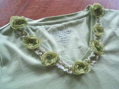 Green tee with flowers around neckline.
