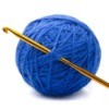 Ball of blue yarn with crochet hook.