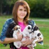 Young woman holding puppies.