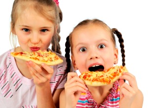 Two girls eating pizza.