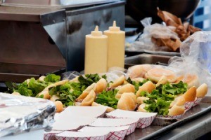 Hamburgers being made at a food festival.