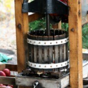 An apple press making apple juice.