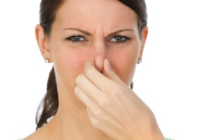 A woman holding her nose.
