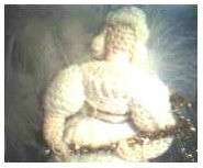 Closeup of angel holding a chenille instrument.