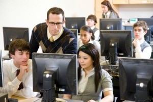 A man teaching a computer class.