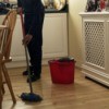 Mopping a wood floor with oil soap.