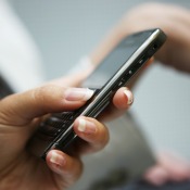 Woman holding a cell phone.