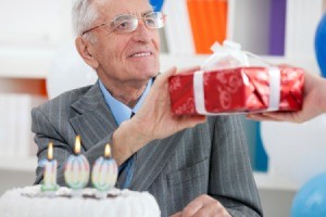 Elderly man receiving a birthday gift