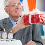 Elderly man receiving a birthday gift