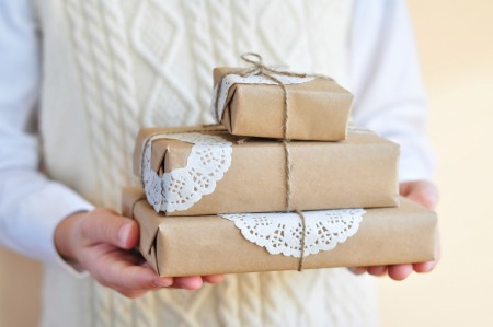 Presents wrapped in paper with doilies as accents.