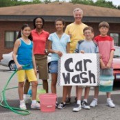 Group of people having a fundraising carwash.