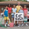 Group of people having a fundraising carwash.