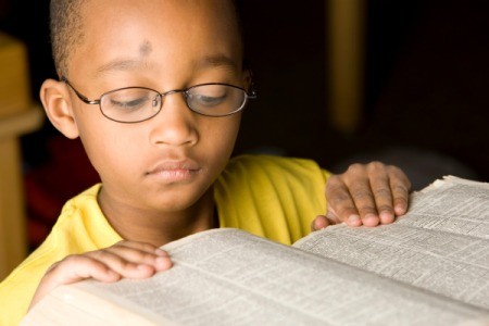 Boy reading a dictionary.