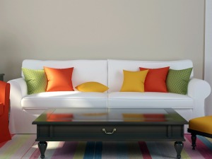 A white couch with colorful pillows.