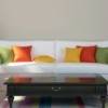 A white couch with colorful pillows.