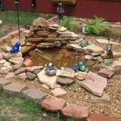 Decorative pond with lots of frog statuary.