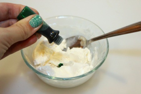 adding green food coloring to cool whip