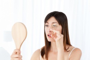 Woman using an Eyelash Curler