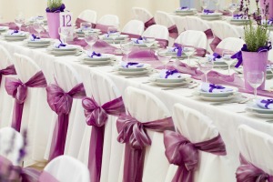 Photo of a wedding reception decorated in purple.