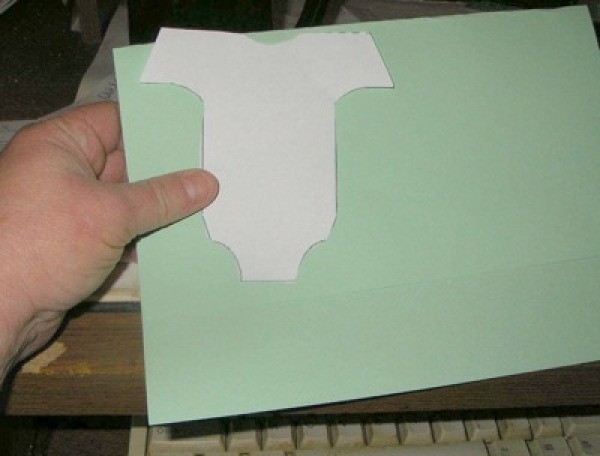 Holding template up to paper.