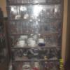 Glass fronted cabinet with shelves.