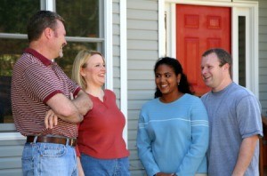 Two couples, who are neighbors, talking.