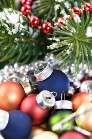 A christmas display with ornaments, cranberries and tinsel.