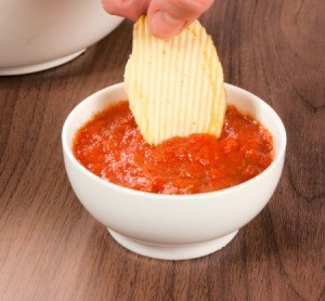 Eating chips and salsa.