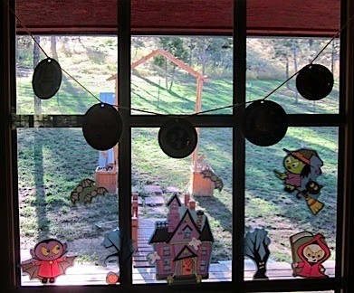 Lid decorations hanging in window.