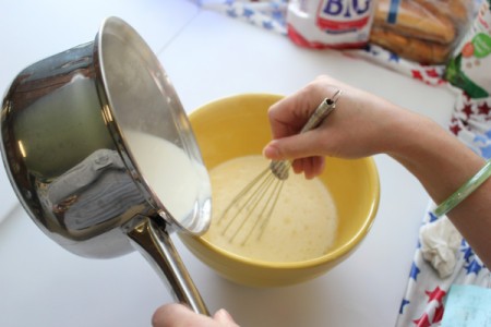 Adding milk and whisking.