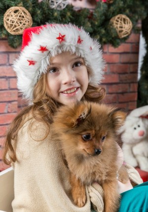 A girl receiving a dog as a gift.