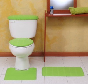 A white toilet with a green toilet seat cover.