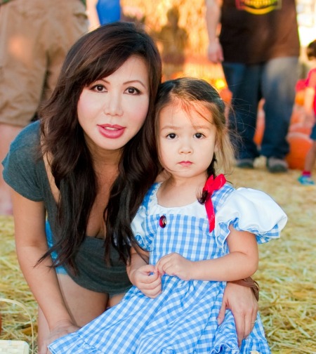 A little girl in a Dorothy costume from Wizard of Oz.