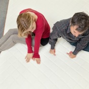 A couple trying out a new mattress in a furniture store.