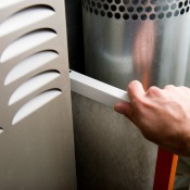 Changing a furnace filter.