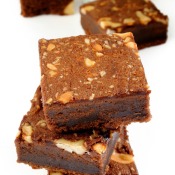 A stack of brownies with nuts.
